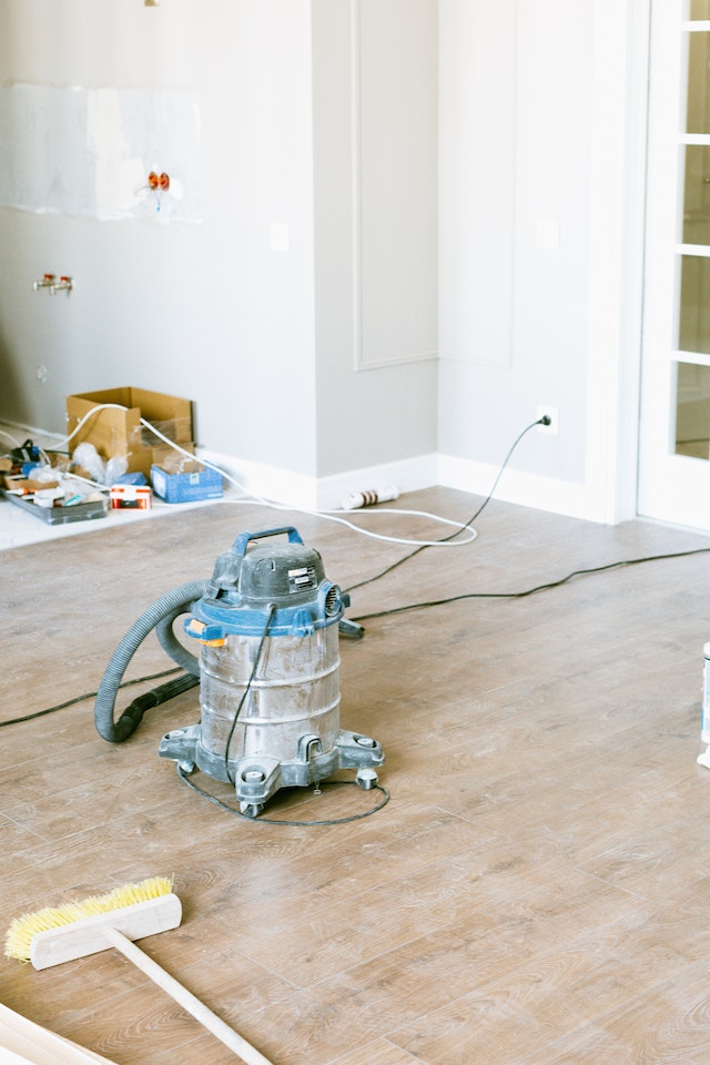 Clean up after new construction or renovations can seem daunting, as shown by this dusty floor and vacuum cleaner in Alachua County Florida.